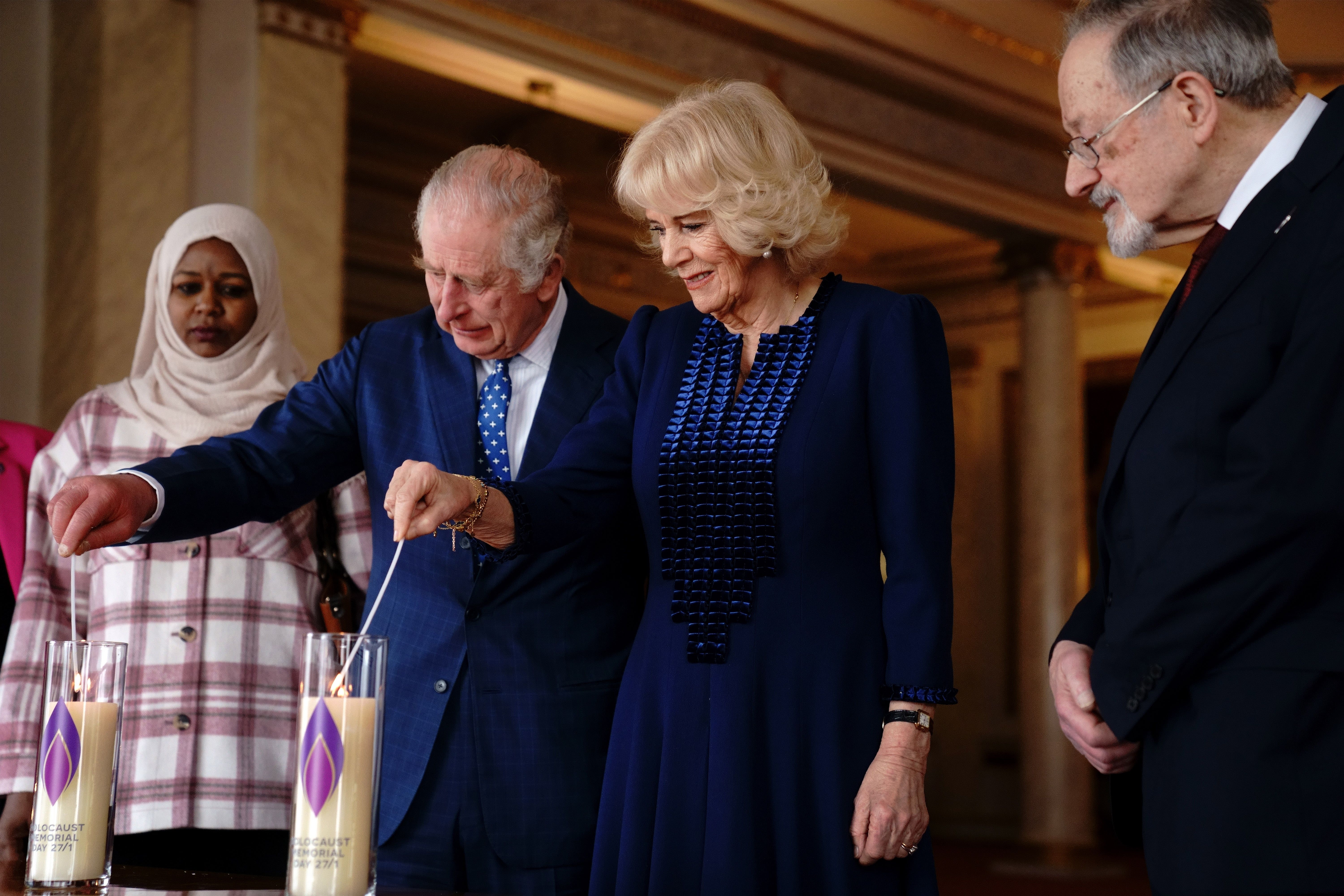 The King and the Queen Consort light a candle at Buckingham Palace to mark Holocaust Memorial Da (Victoria Jones/PA)