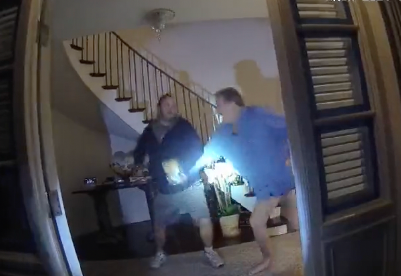 A screen grab from police bodycam footage shows Paul Pelosi and an intruder identified as David DePape