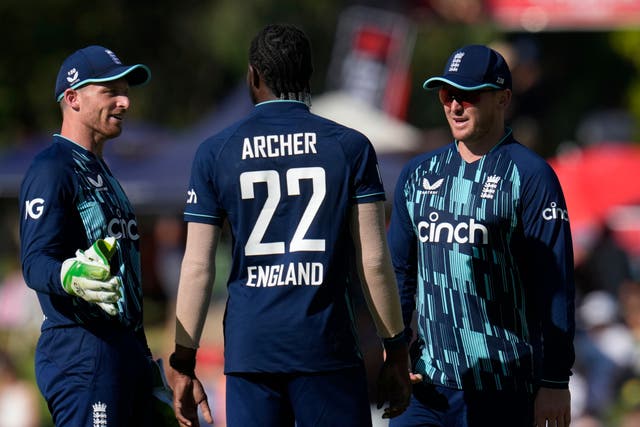 England captain Jos Buttler, left, with Jason Roy, right, celebrate with bowler Jofra Archer for taking a wicket (Themba Hadebe/AP)