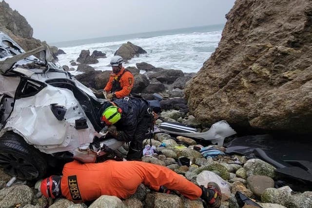 <p>In this photo provided by the San Mateo County Sheriff's Office, emergency personnel respond to a vehicle over the side of Highway 1 on 1 January 2023, in San Mateo County, California</p>