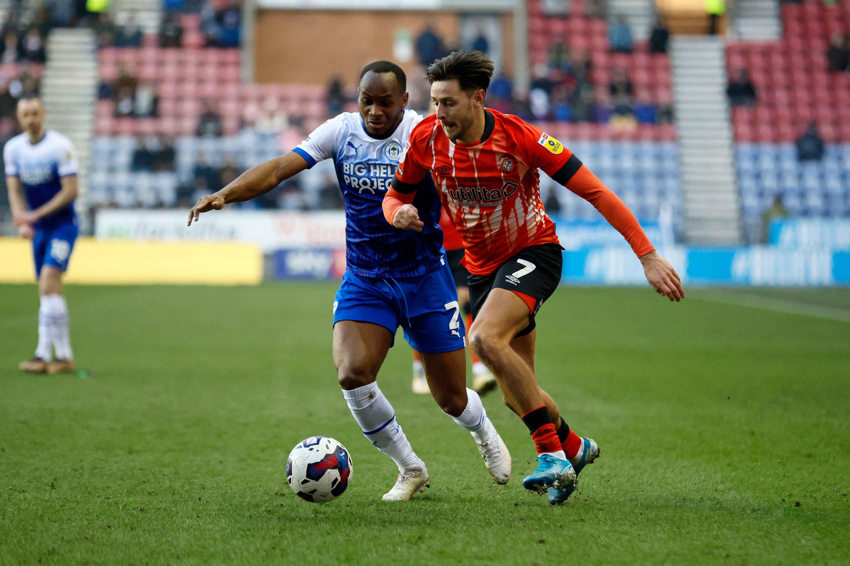 Luton Town’s Harry Cornick and Wigan Athletic’s Ryan Nyambe challenge for the ball