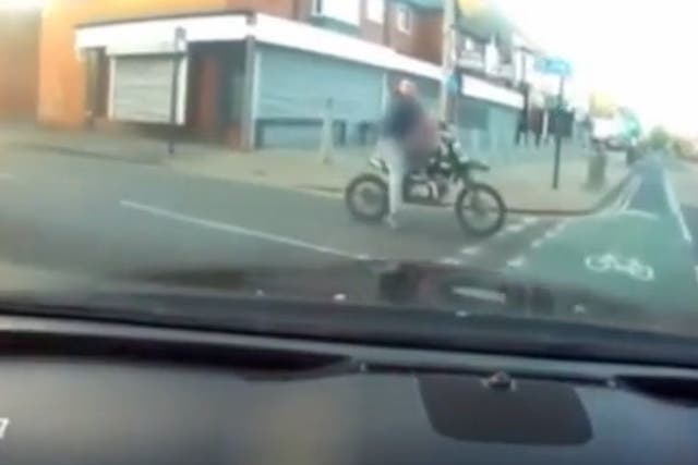 <p>Shocking CCTV released of father dodging traffic while toddler balances on motorbike</p>