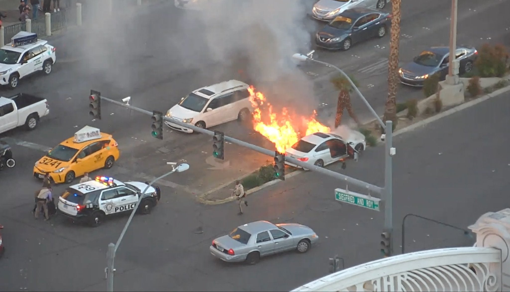 <p>A police officer and bystander saved the driver of a white sedan from a fiery crash on the Las Vegas strip on Friday</p>