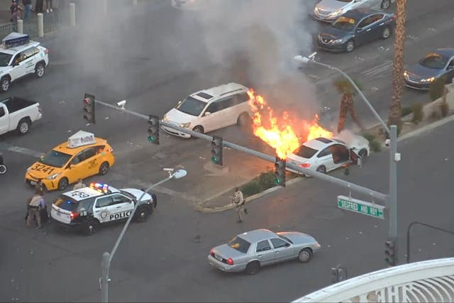 <p>A police officer and bystander saved the driver of a white sedan from a fiery crash on the Las Vegas strip on Friday</p>