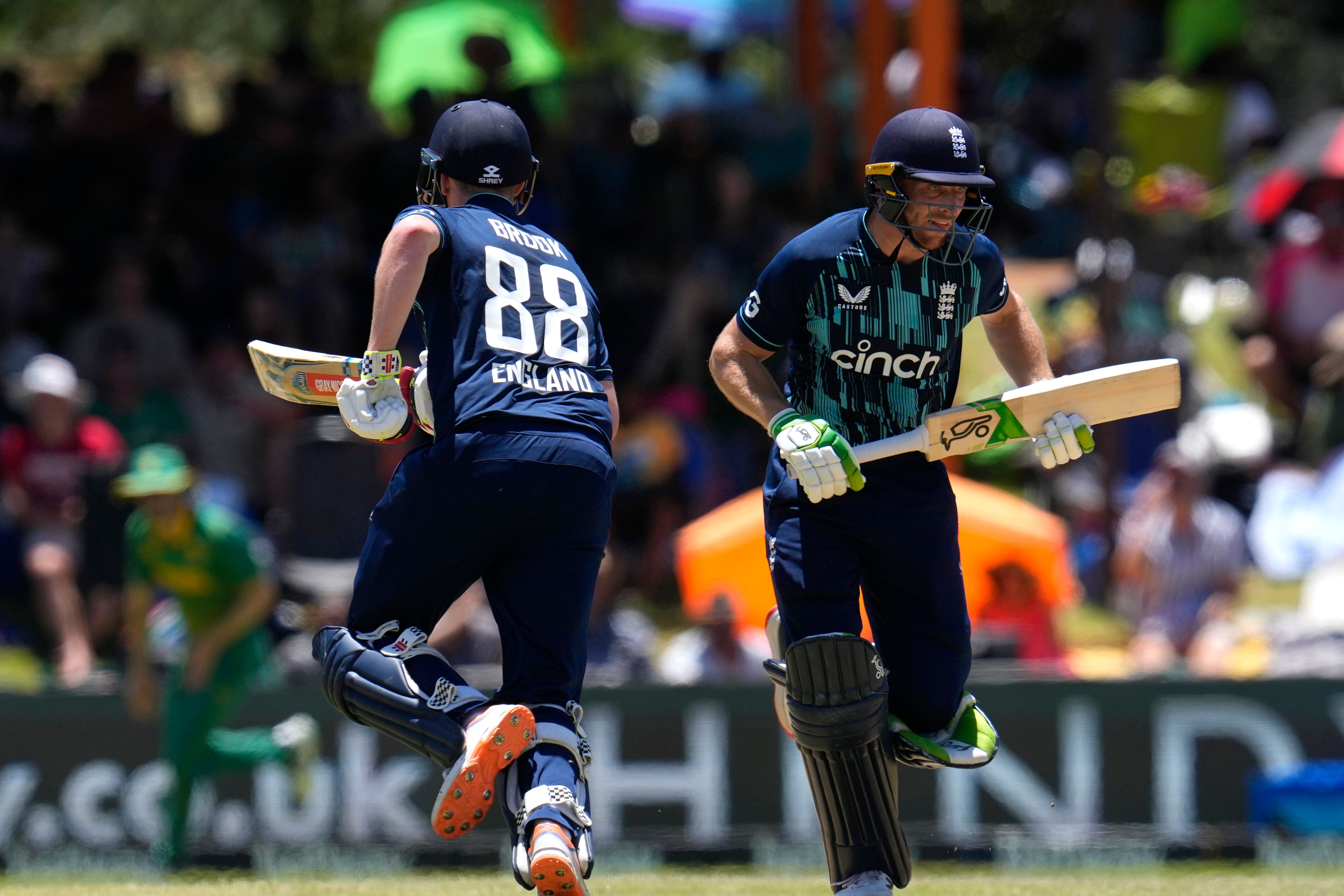 England’s captain Jos Buttler, right, with teammate Harry Brook run between the wickets, during the second One-Day International cricket match between South Africa and England at Mangaung Oval in Bloemfontein, South Africa, Sunday, Jan. 29, 2023. (AP Photo/Themba Hadebe)
