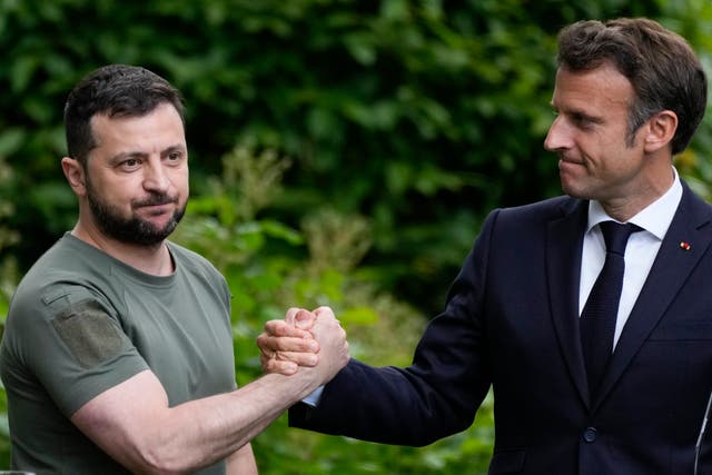 <p>Ukraine president Volodymyr Zelensky and France's president Emmanuel Macron shake hands at the end of a press conference at the Mariyinsky Palace in Kyiv, Ukraine in 2022 </p>