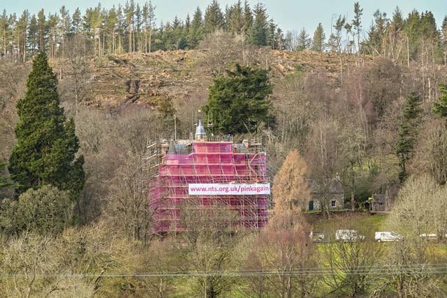 The castle has been swathed in pink mesh (Michal Wachucik/Abermedia/NTS/PA)