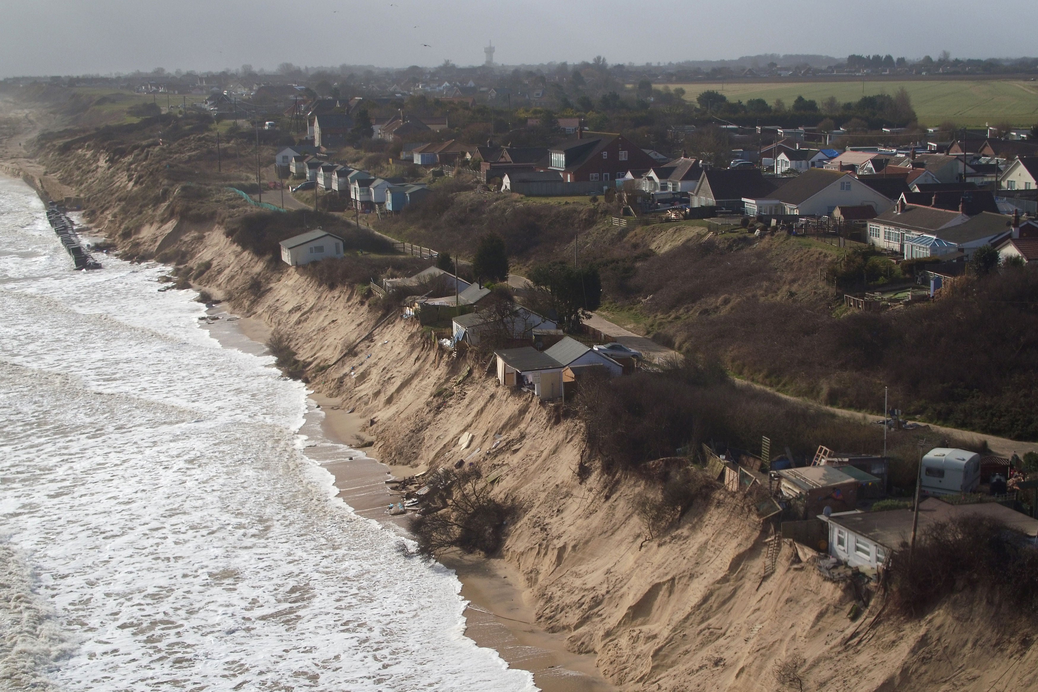 Houses sitting on the cliff edge on The Marrams in Hemsby, Norfolk.