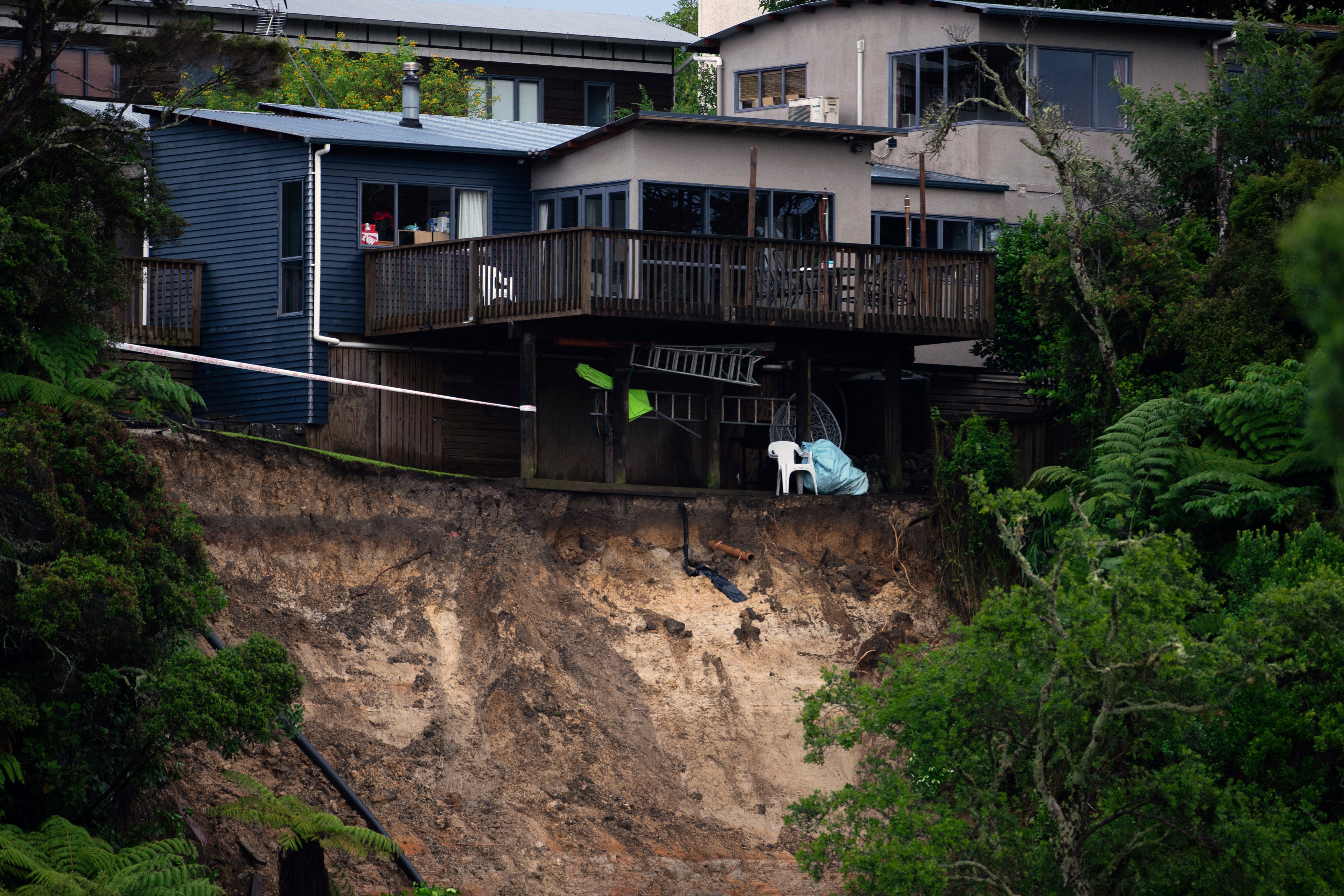 A landslip undermines a house in Auckland after last week’s rain