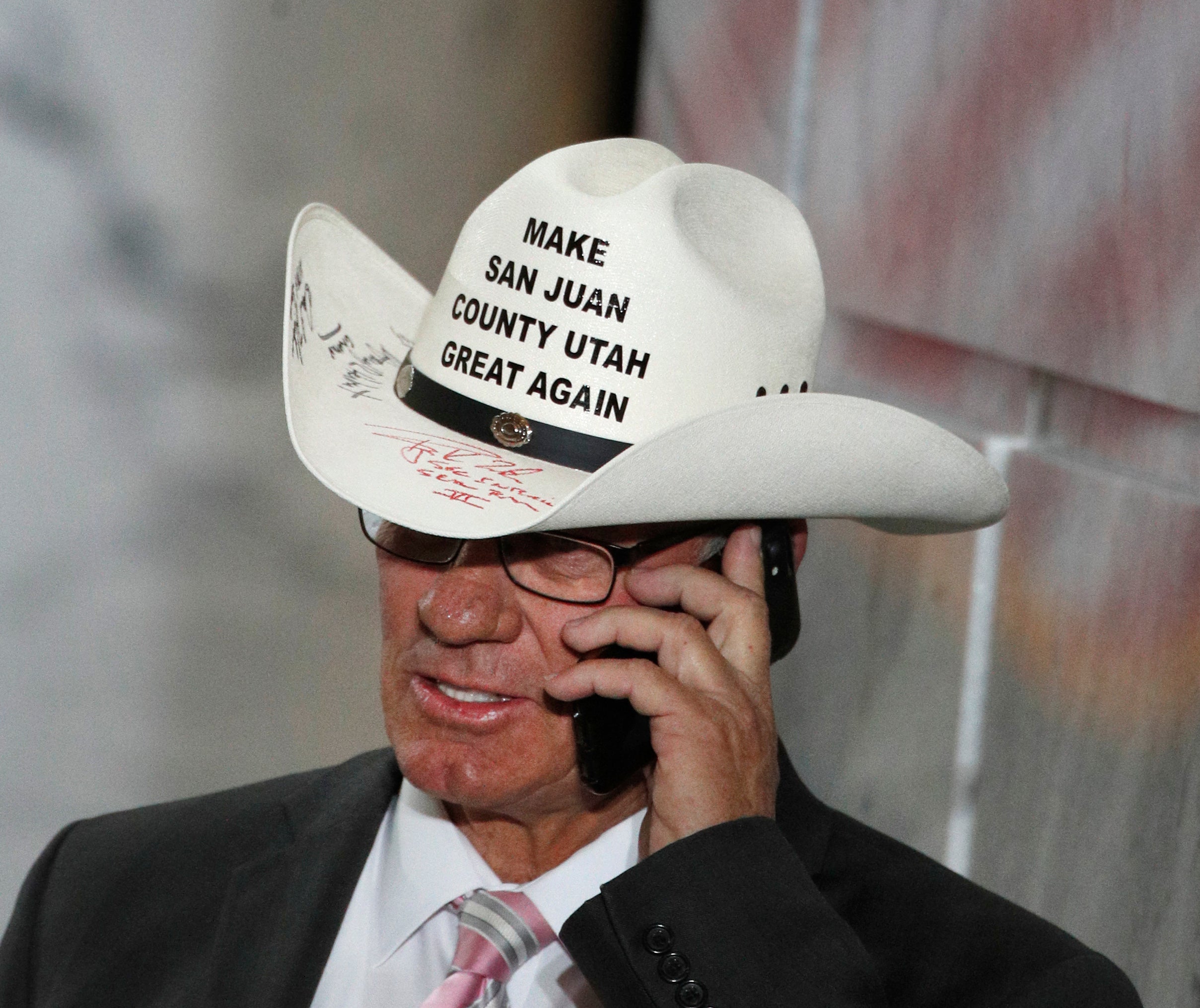 Bruce Adams, Chairman of the San Juan County Commission, talks on the phone before a event with U.S. President Donald Trump at the Rotunda of the Utah State Capitol on December 4, 2017