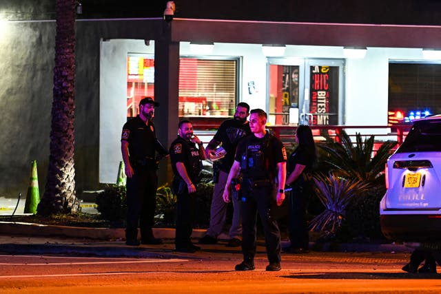 <p>File photo: Miami Gardens Police officers walk out of the The Licking restaurant in Miami Gardens, Florida on 5 January 2023 </p>