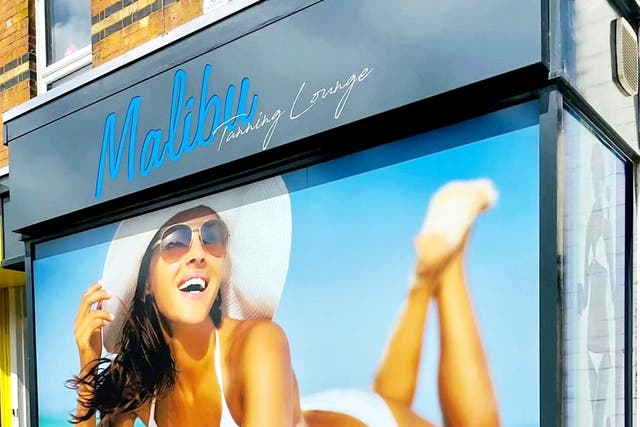 <p>A tanning salon has been ordered to remove an 'offensive' shop front display of a sunbathing woman because it's not in keeping with the image of a historic market town</p>