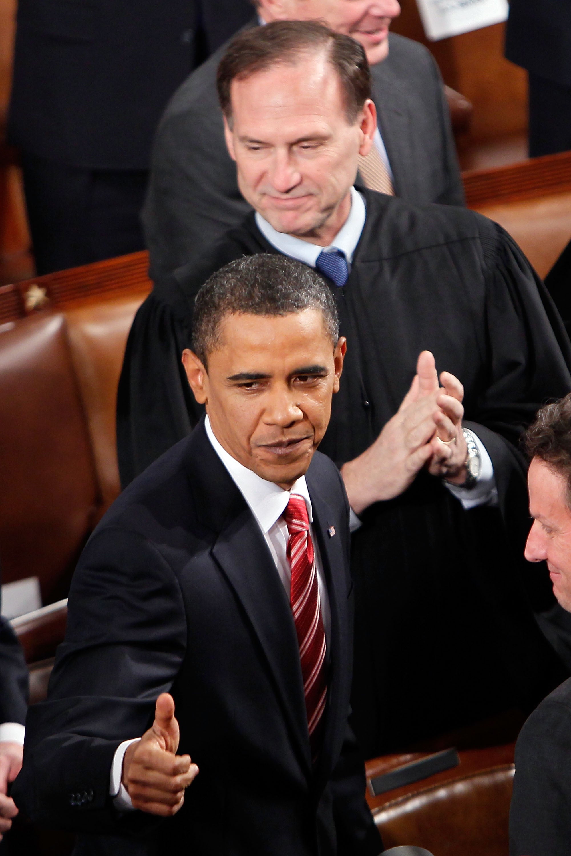 Supreme Court Justice Samuel Alito looks on on as U.S. President Barack Obama enters the chamber before speaking to both houses of Congress during his first State of the Union address