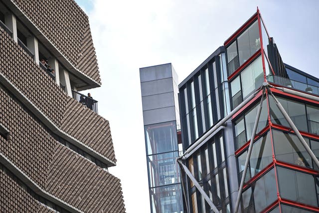 The owners living in residential flats (right) which are over looked by the Tate Modern (PA)
