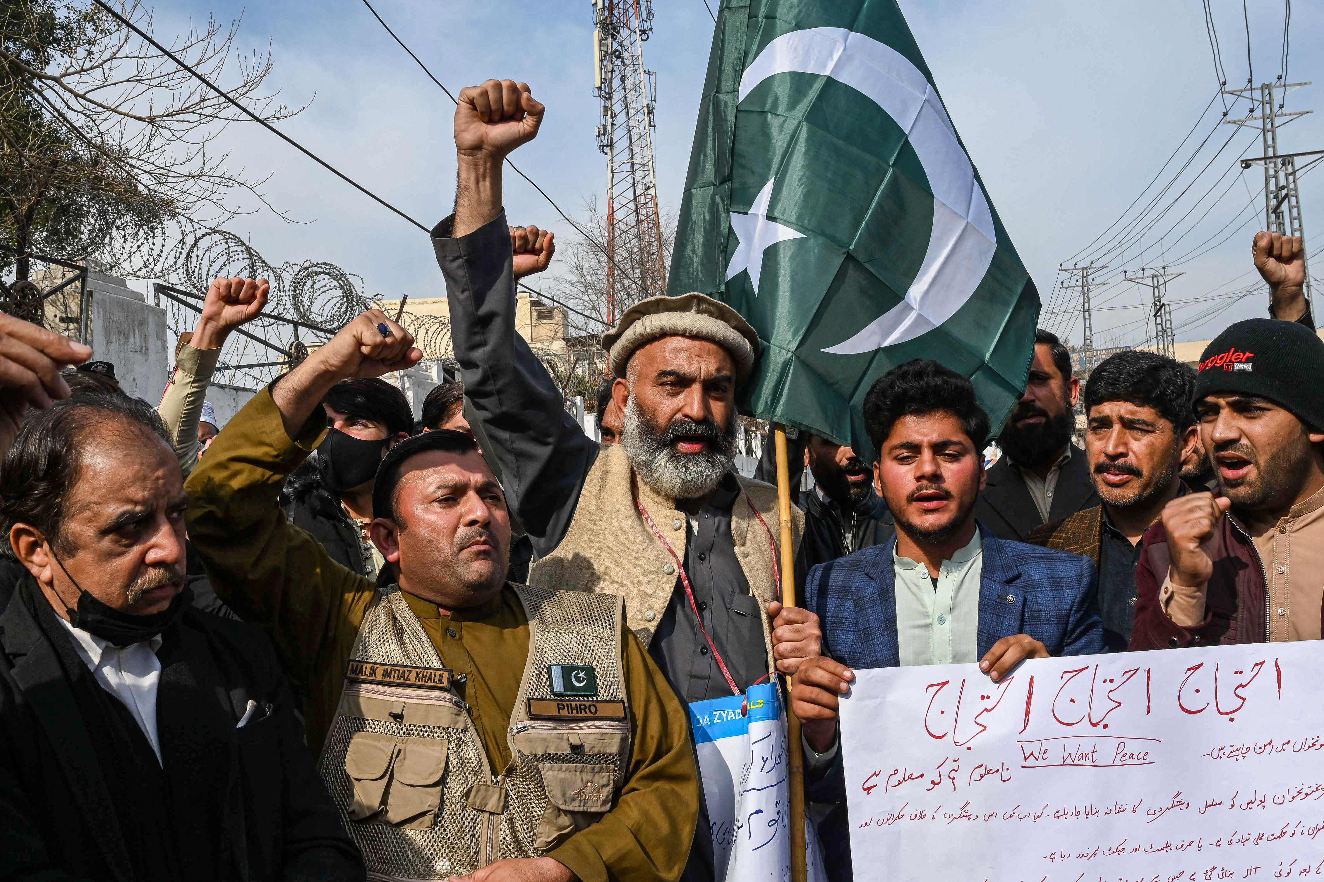 Family members of mosque blast victims and social activists chant slogans during a protest against the militancy and the mosque suicide blast inside a police headquarters in Peshawar