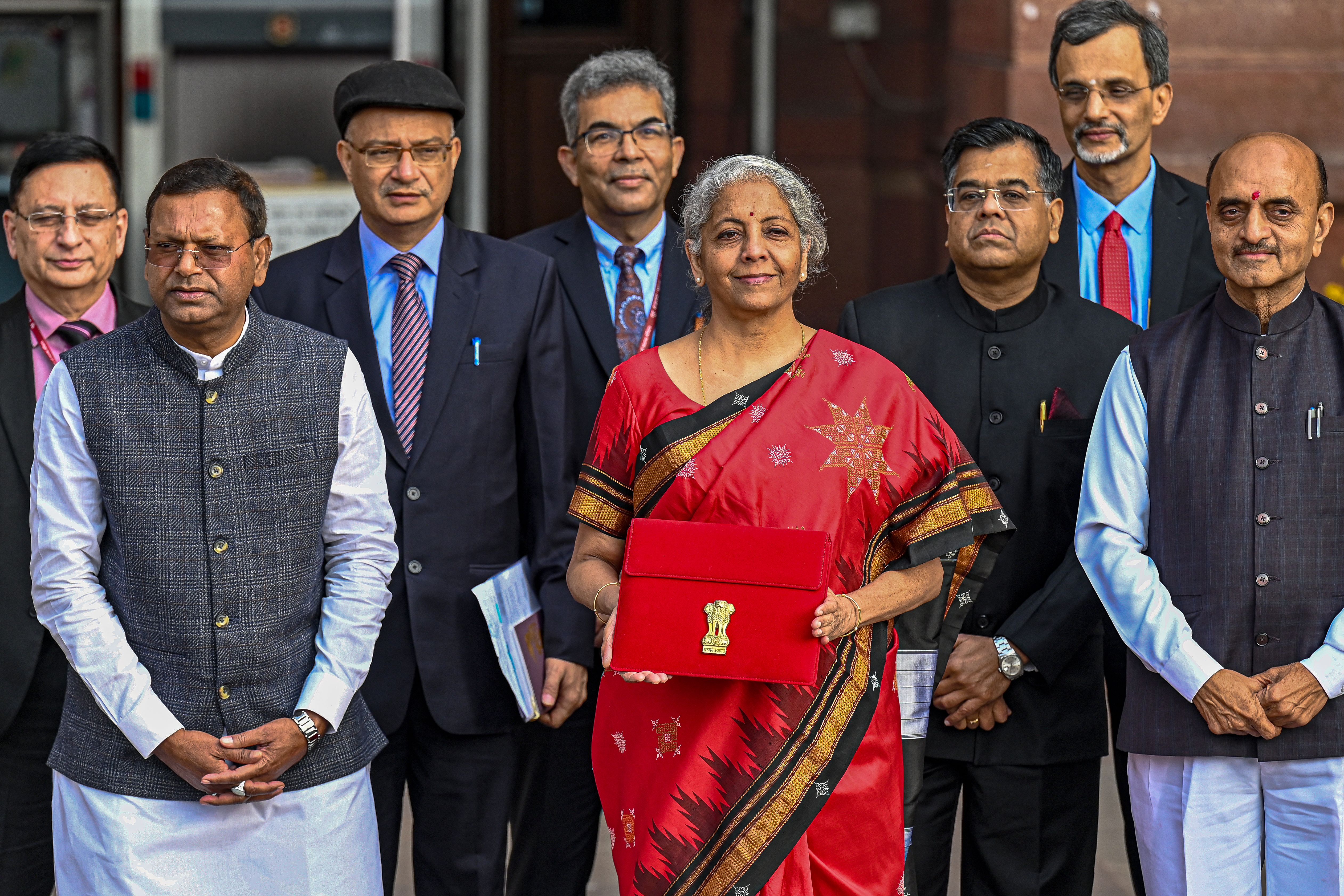 India’s finance minister Nirmala Sitharaman (centre) poses for a photograph as she leaves the finance ministry to present the annual budget in the parliament in New Delhi