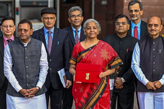 <p>India’s finance minister Nirmala Sitharaman (centre) poses for a photograph as she leaves the finance ministry to present the annual budget in the parliament in New Delhi</p>