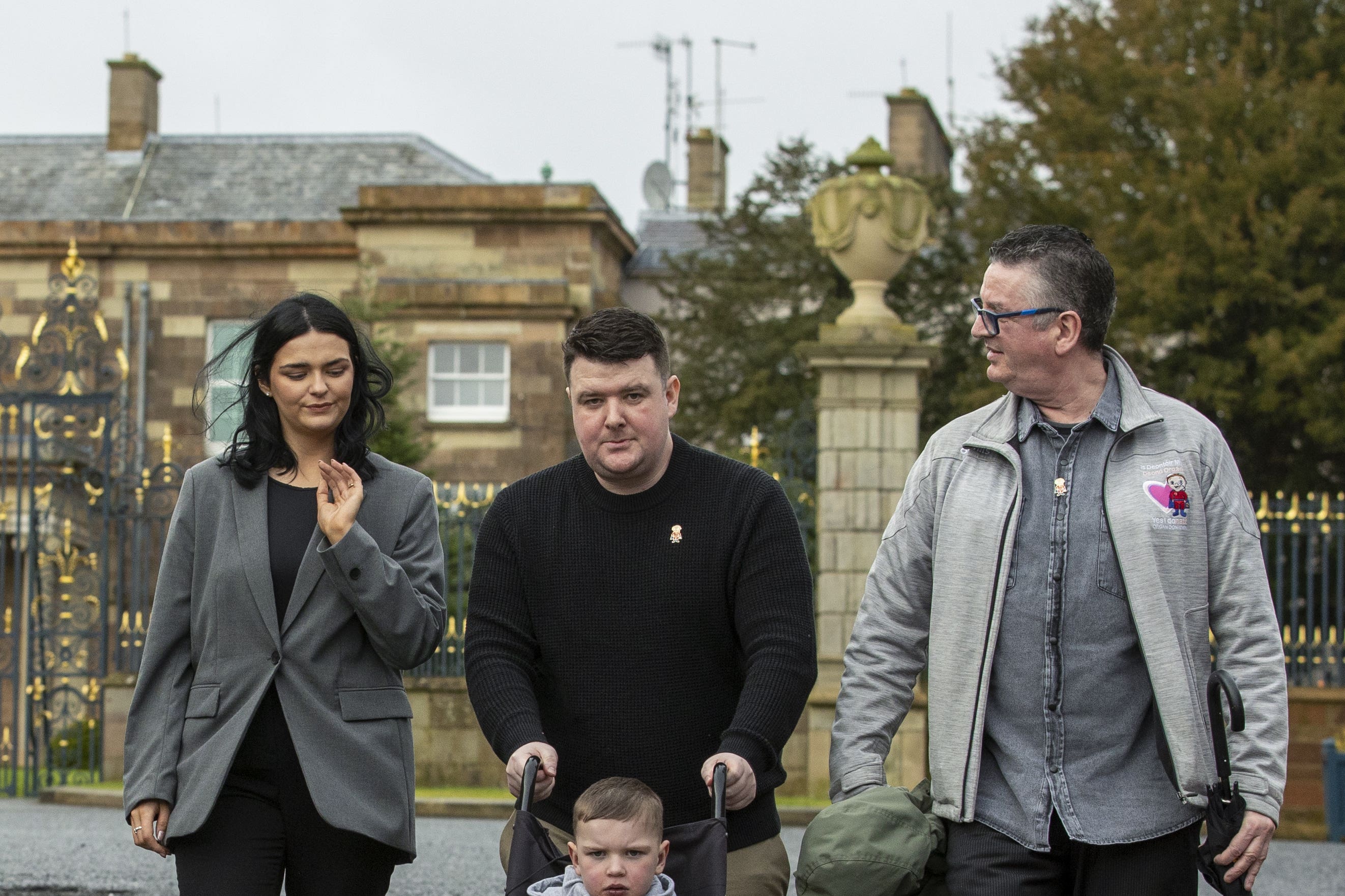 Mairtin MacGabhann and Seph Ni Mheallain with their son of Daithi MacGabhann, six, and his grandfather Martin Smith, outside Hillsborough Castle in Northern Ireland, after they met with Northern Ireland Secretary Chris Heaton-Harris to discuss delays implementing new organ donation laws in the region (Liam McBurney/PA)