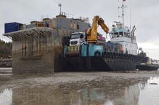 ‘Toxic’ barge that sank more than a year ago is still beached in a scenic bay