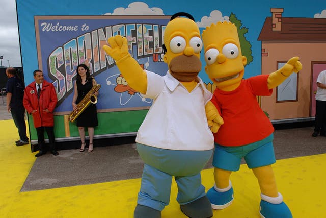 People dressed as Homer (left) and Bart Simpson arrive for the UK Premiere of The Simpsons Movie (Joel Ryan/PA)