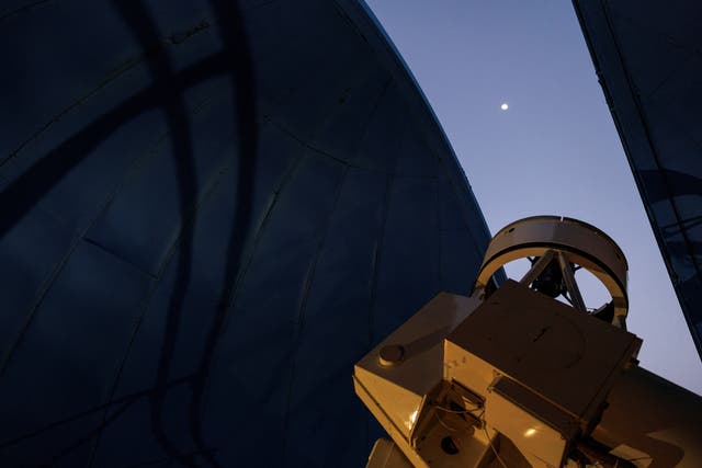 <p>The moon is seen through the open canopy of the Kryoneri Observatory, before the telescope tracks a green comet named Comet C/2022 E3 (ZTF), in Kryoneri, Greece, February 1, 2023. </p>