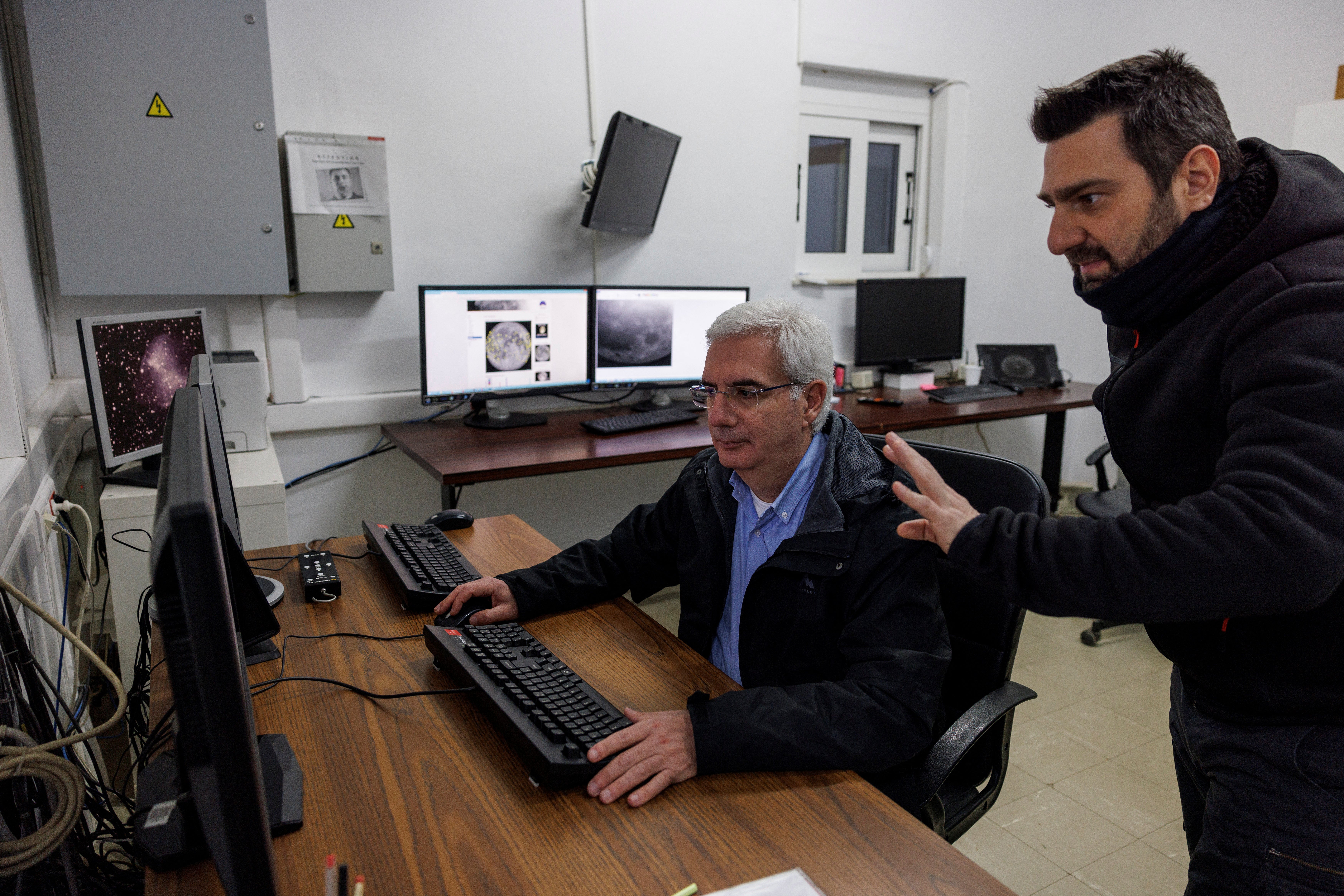 Post doctoral researcher Alexios Liakos talks to senior researcher Manolis Xylouris, as they track a green comet named Comet C/2022 E3 (ZTF) from the telescope of the Kryoneri observatory, in Kryoneri, Greece, February 1, 2023.
