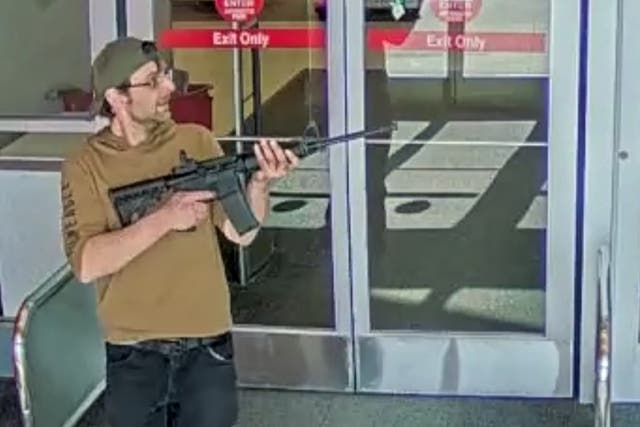 <p>Joseph Jones, 32, pictured with a gun at an Omaha Target before being shot dead by police</p>