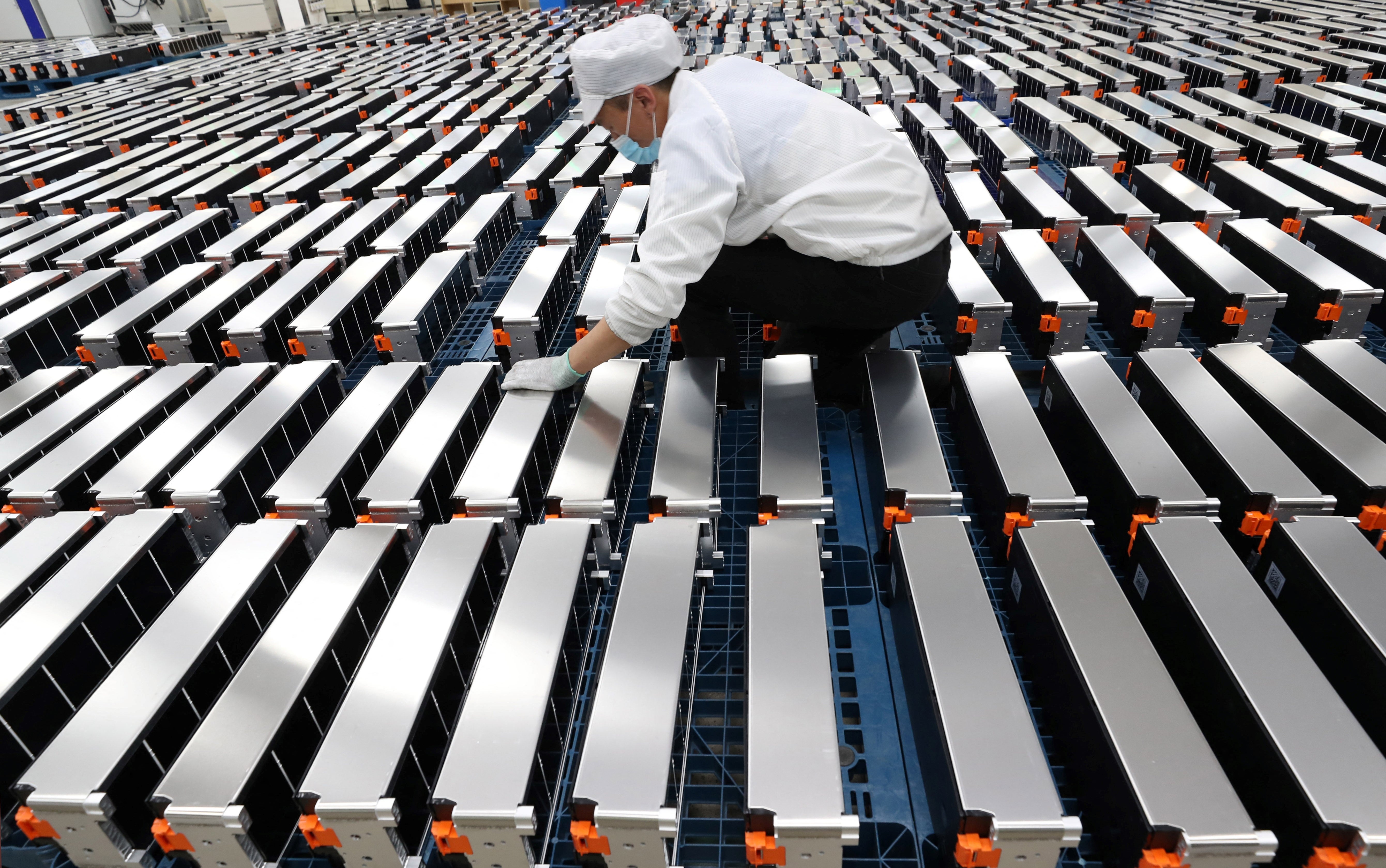 A worker with car batteries at a factory for Xinwangda Electric Vehicle Battery Co Ltd in China’s eastern Jiangsu province
