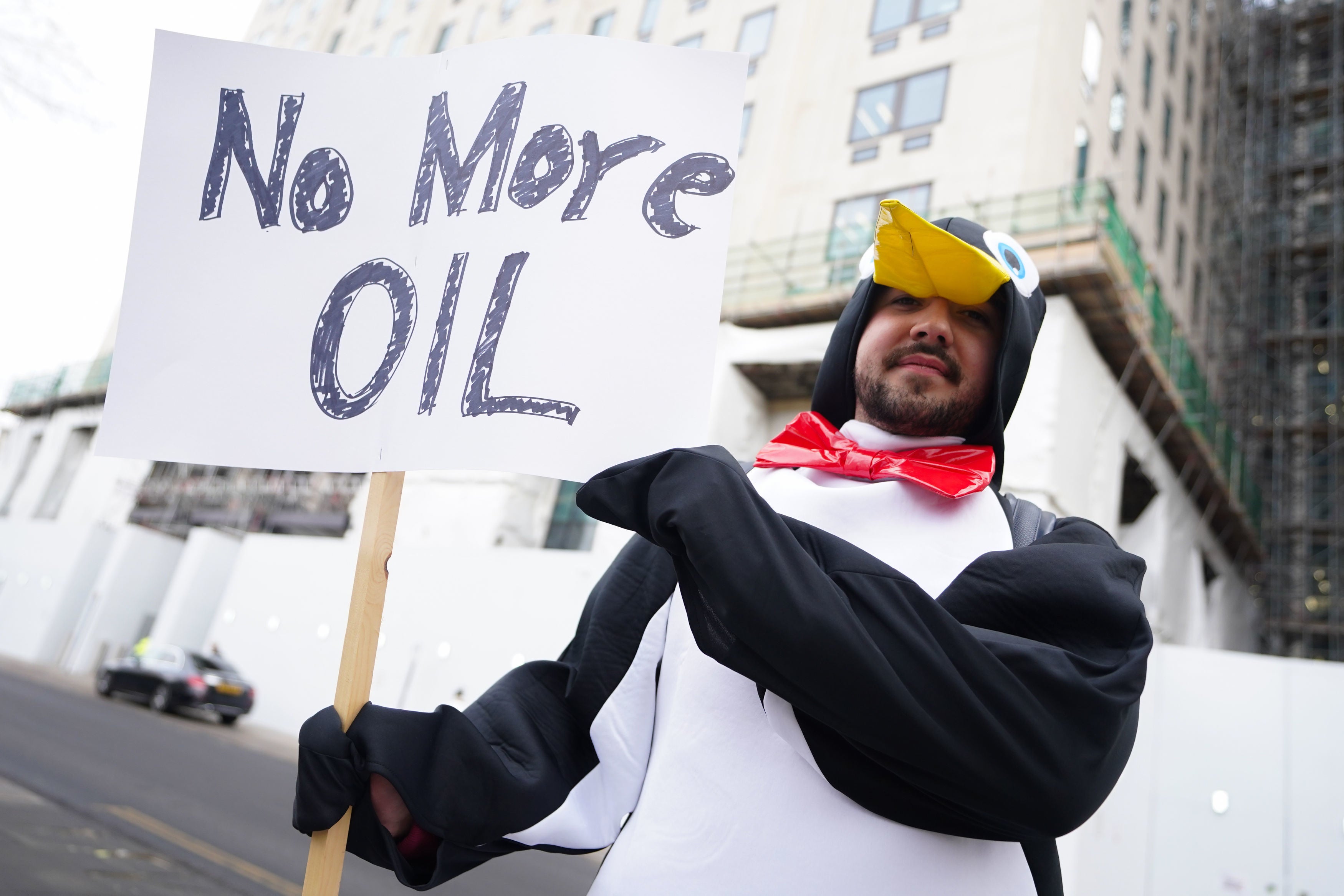 A demonstrator dressed as penguin outside Shell’s HQ in Lambeth, south east London as the firm announced record profits