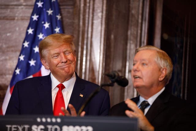 <p>Former US President Donald Trump gestures as US Senator Lindsey Graham (R-SC) addresses the crowd during a 2024 election campaign event in Columbia, South Carolina, on January 28, 2023</p>