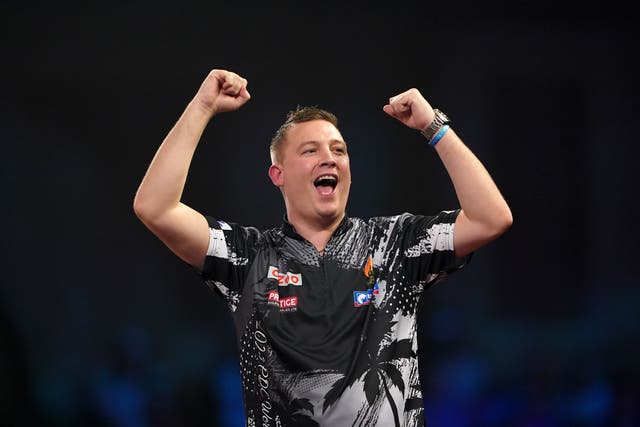 Chris Dobey celebrated a memorable victory over Michael Van Gerwen to move top of the Premier League on opening night (Zac Goodwin/PA)
