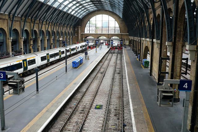 Empty platform and a stationary train at Kings Cross station in London (PA)