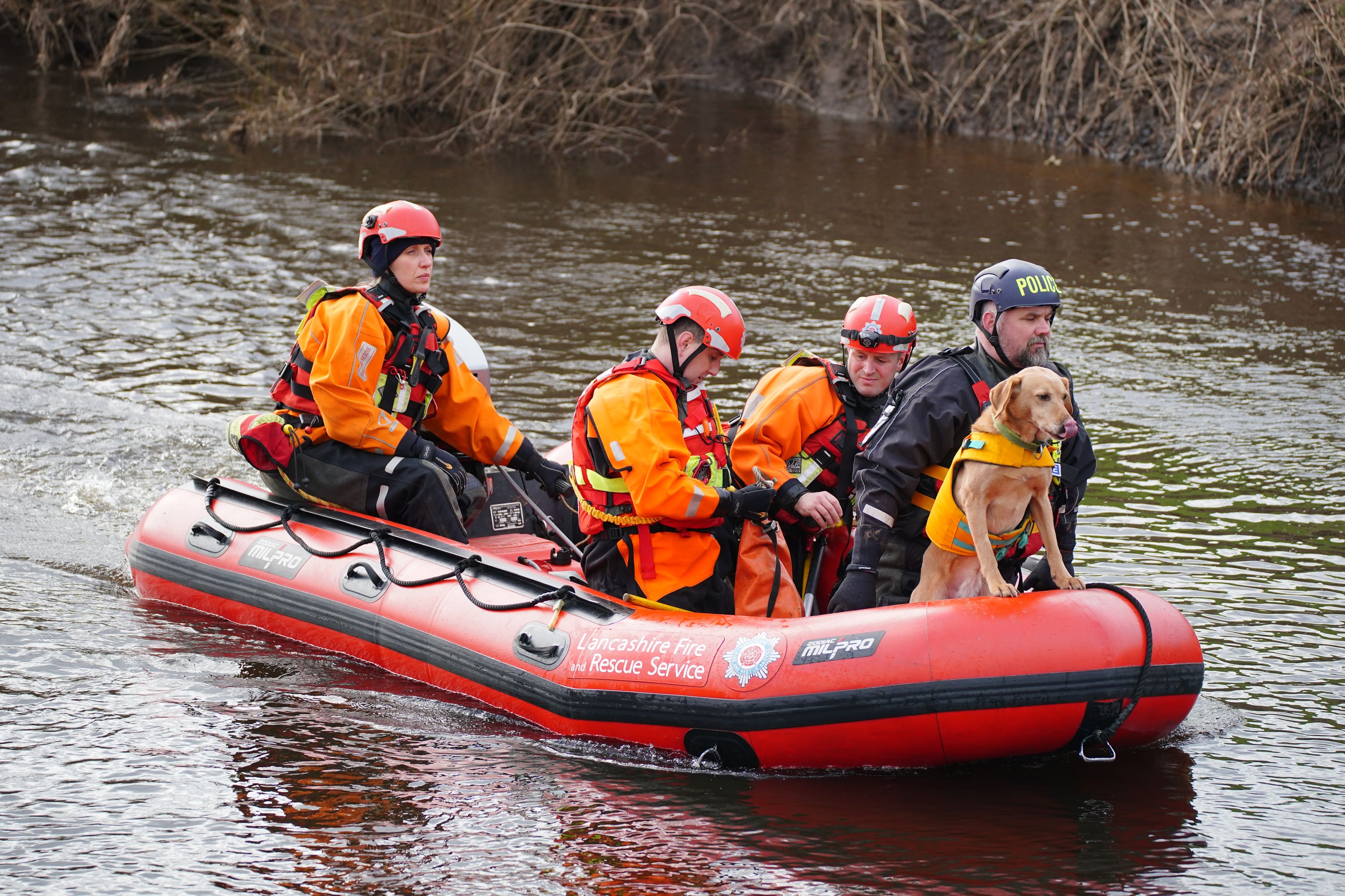 Specialist search teams from Lancashire Fire and Rescue Service and the police, on the River Wyre