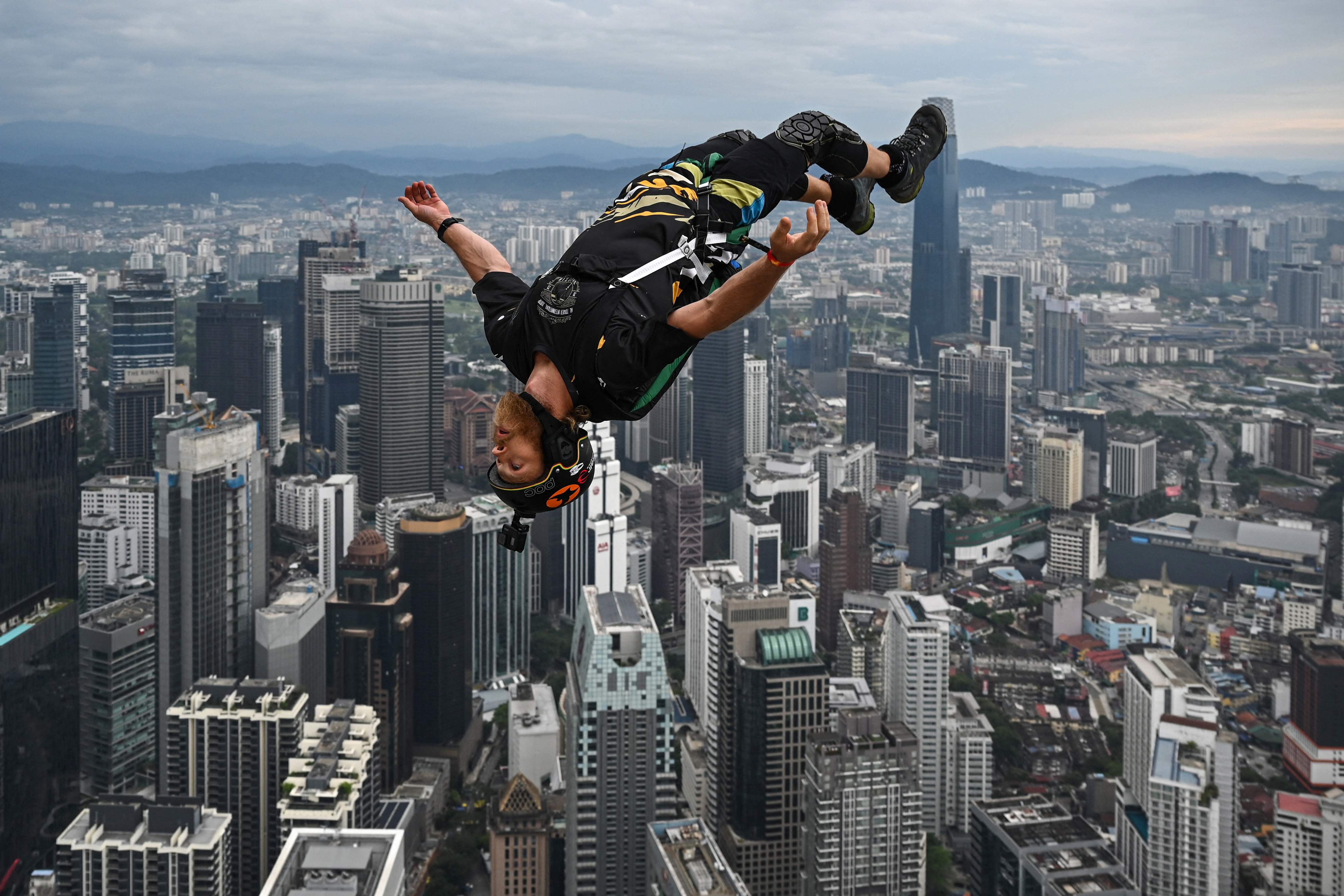 Base jumper Connor Young of Australia leaps from the 300-metre high open deck of Malaysia's landmark Kuala Lumpur Tower during the International Tower Jump in Kuala Lumpur