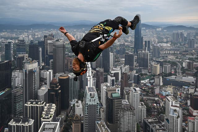 <p>Base jumper Connor Young of Australia leaps from the 300-metre high open deck of Malaysia's landmark Kuala Lumpur Tower during the International Tower Jump in Kuala Lumpur</p>