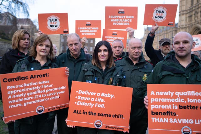 Ambulance workers from the GMB union outside the Houses of Parliament (PA)