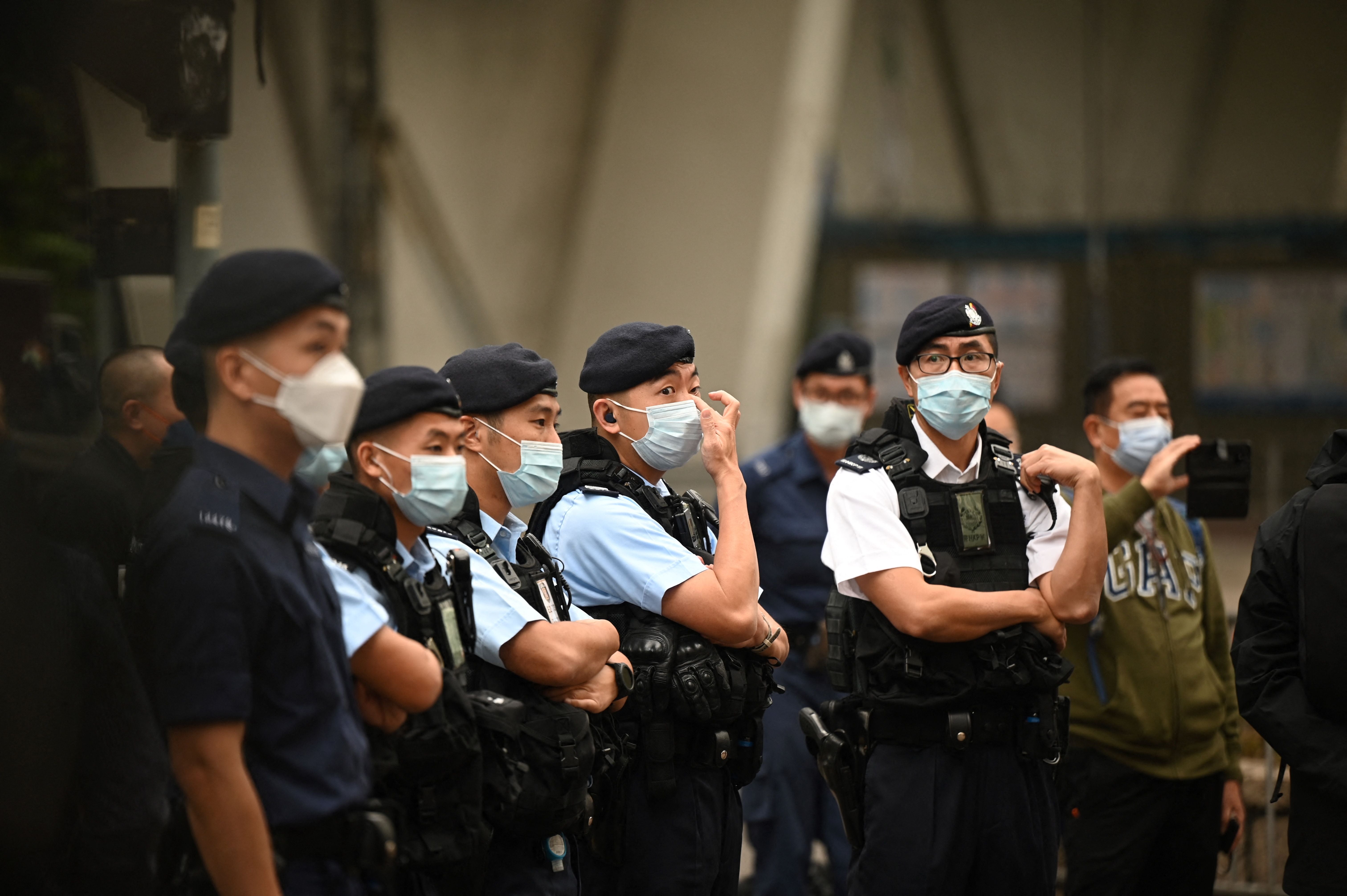 File. Police keep watch outside a court in Hong Kong on February 6, 2023 as the trial of 47 of Hong Kongs most prominent pro-democracy figures begins in the largest prosecution under a national security law that has crushed dissent in the city