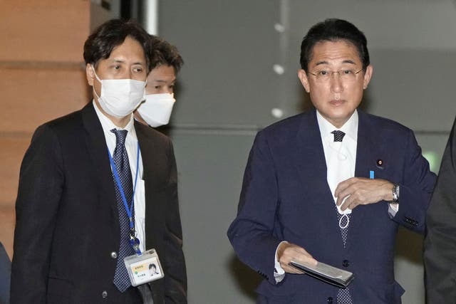 <p>Senior aide to the prime minister Masayoshi Arai, left, walks next to Prime Minister Fumio Kishida </p>