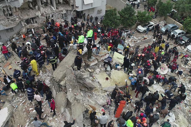 <p>People search through rubble in Adana following the earthquake </p>