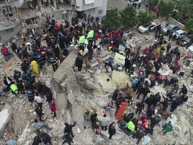 <p>People search through rubble in Adana following the earthquake </p>