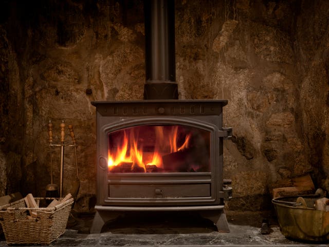 <p>A fireplace with a wood burning stove</p>
