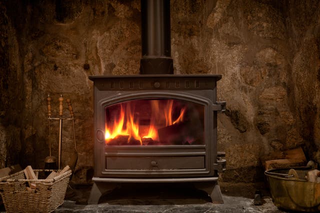 <p>A fireplace with a wood burning stove</p>