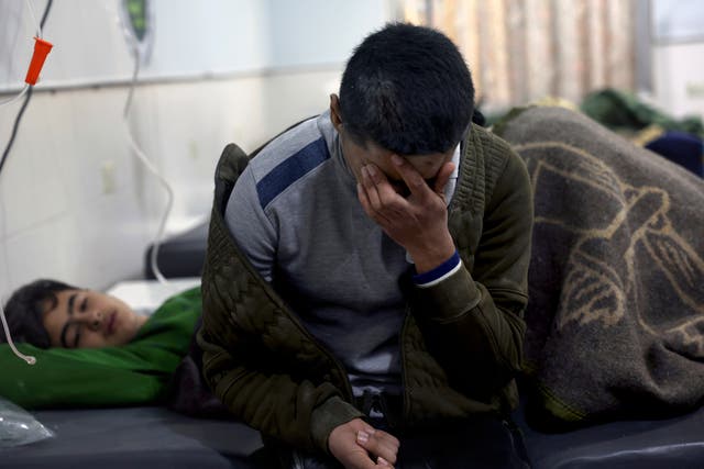 <p>Earthquake victims receive treatment at the al-Rahma Hospital in the town of Darkush, Idlib province</p>