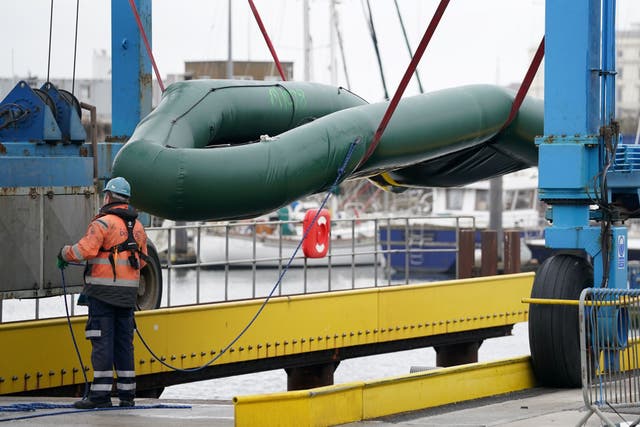 Small boats used to cross the Channel by people thought to be migrants are removed from the water and documented at the Port of Dover in Kent before being taken away for storage (Gareth Fuller/PA)