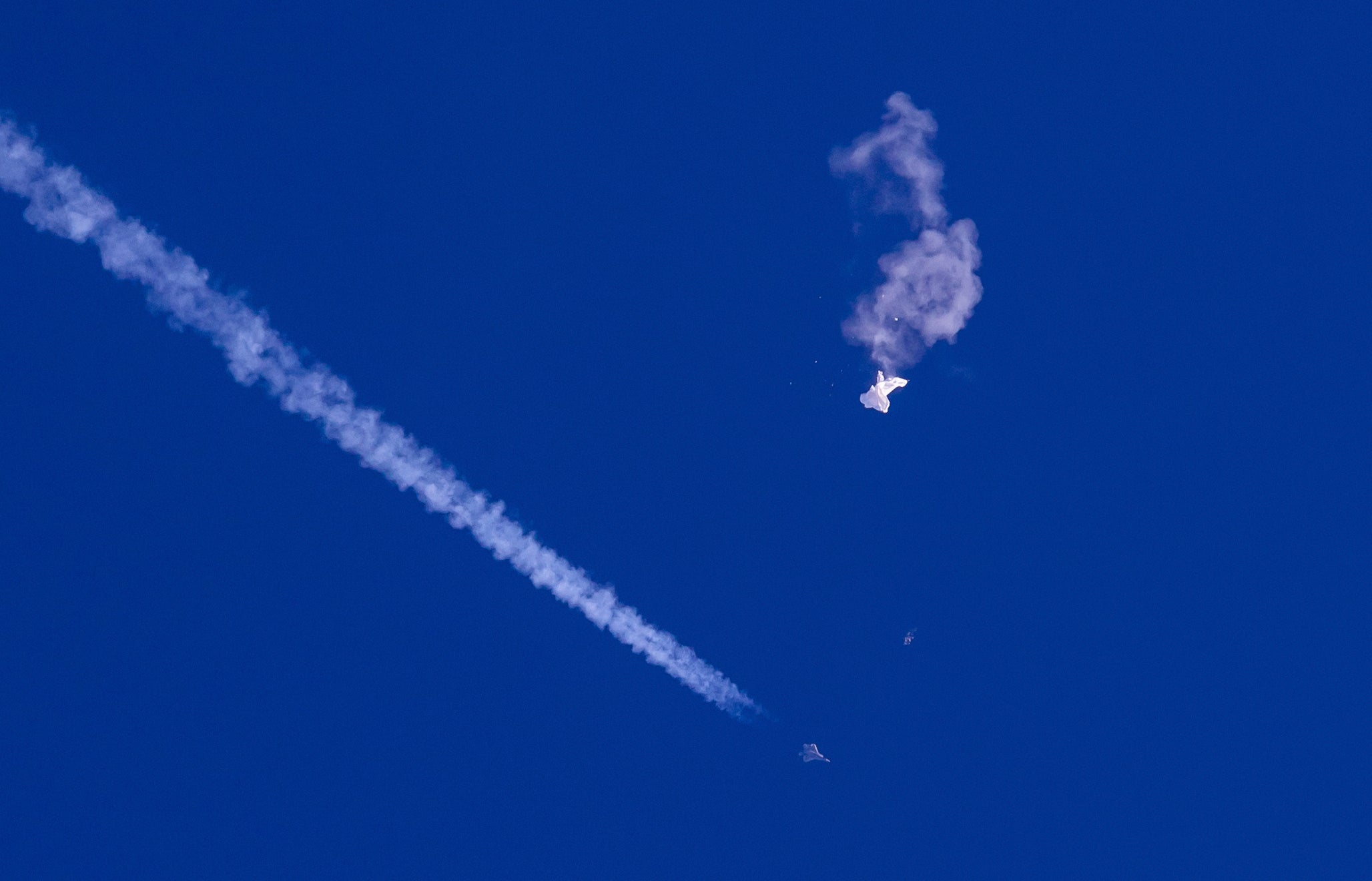 The remnants of a large balloon drift above the Atlantic Ocean