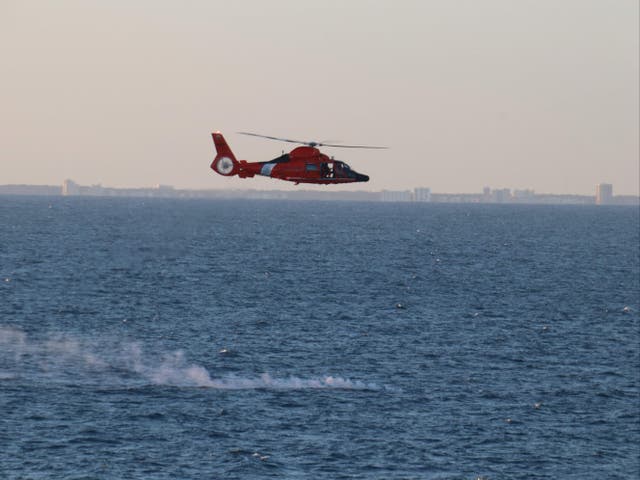 <p>A US Coast Guard helicopter flies over a debris field during recovery efforts of a high-altitude surveillance balloon in the Atlantic ocean</p>