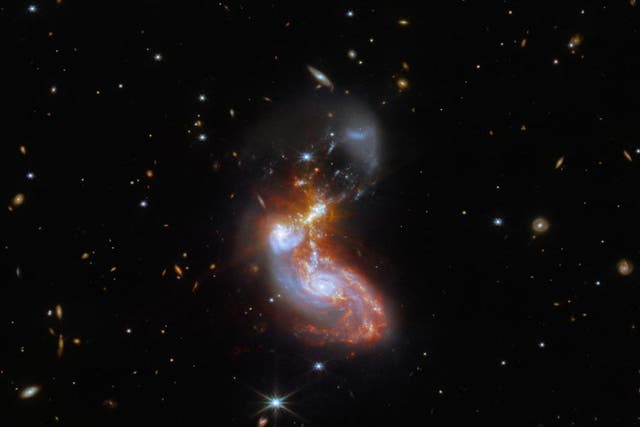 <p>Merging galaxy pair about 500 million light-years away toward constellation Delphinus</p>