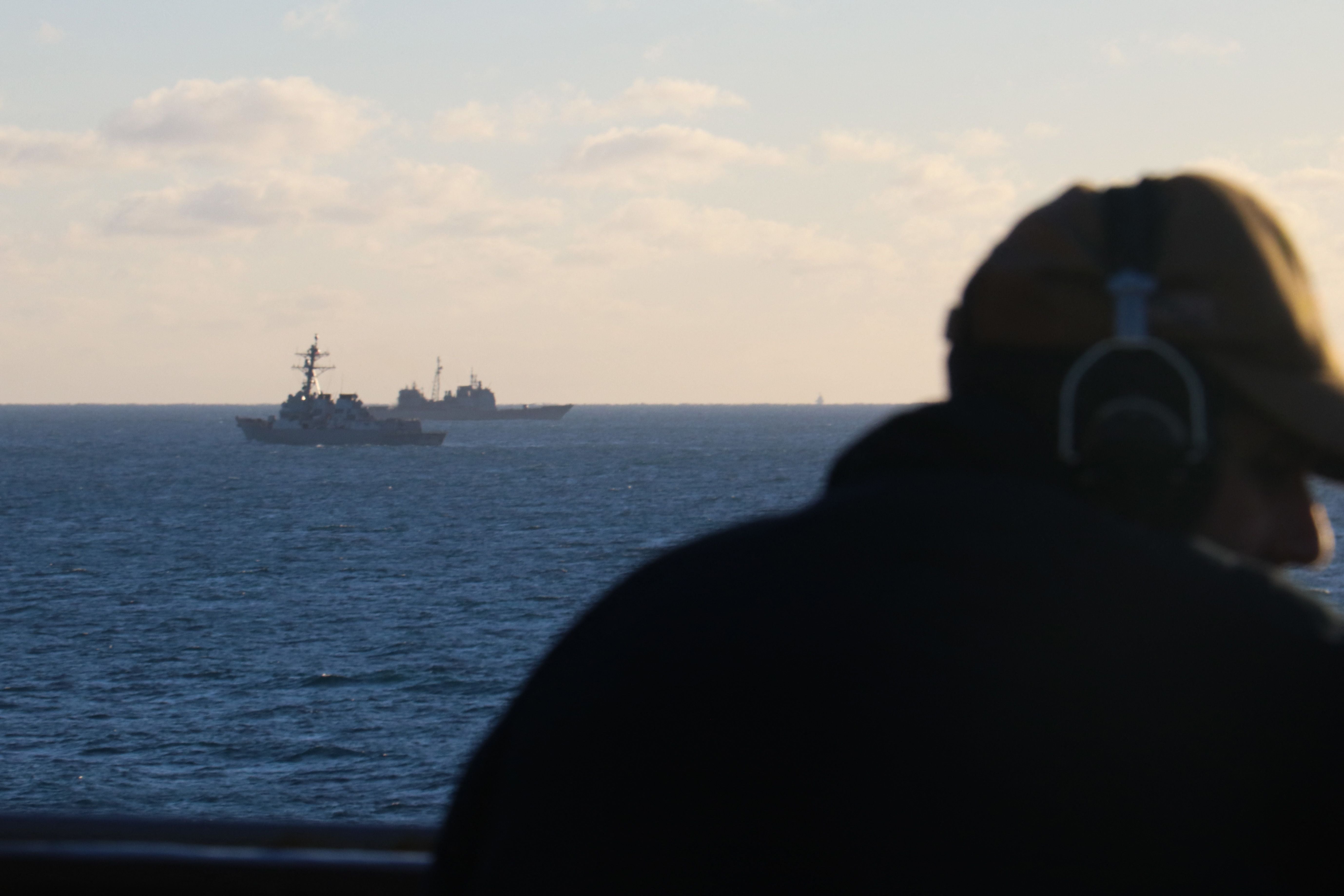 Seaman Rafael Mendez stands watch aboard the dock landing ship USS Carter Hall