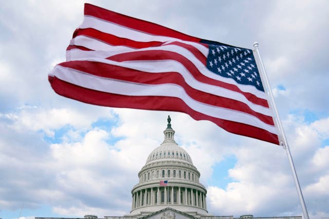 <p>The top of the US Capitol building and the American flag in Washington, DC </p>