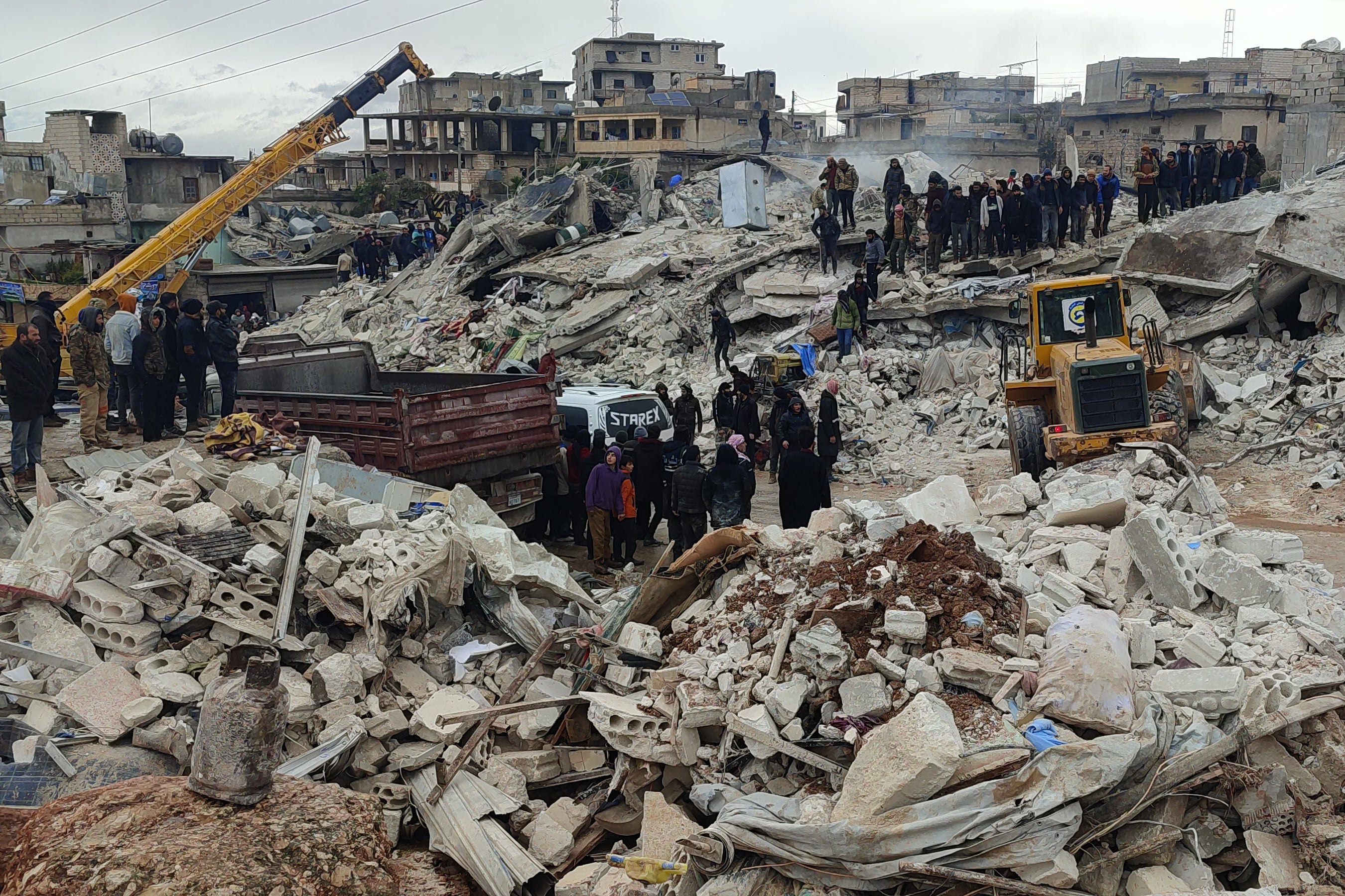 Search and rescue teams continue their work at the collapsed buildings, in Idlib, Syria